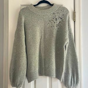 Grey sweater with embellishments and puff sleeves